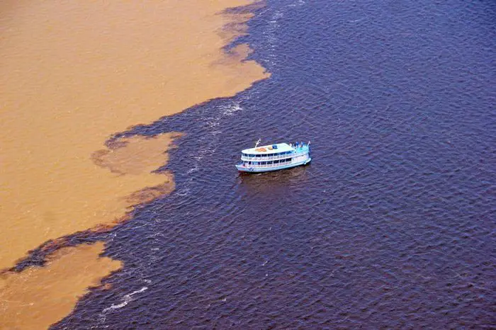قارب في التقاء نهري (ريو نيغرو) الأسود و(سوليموس)