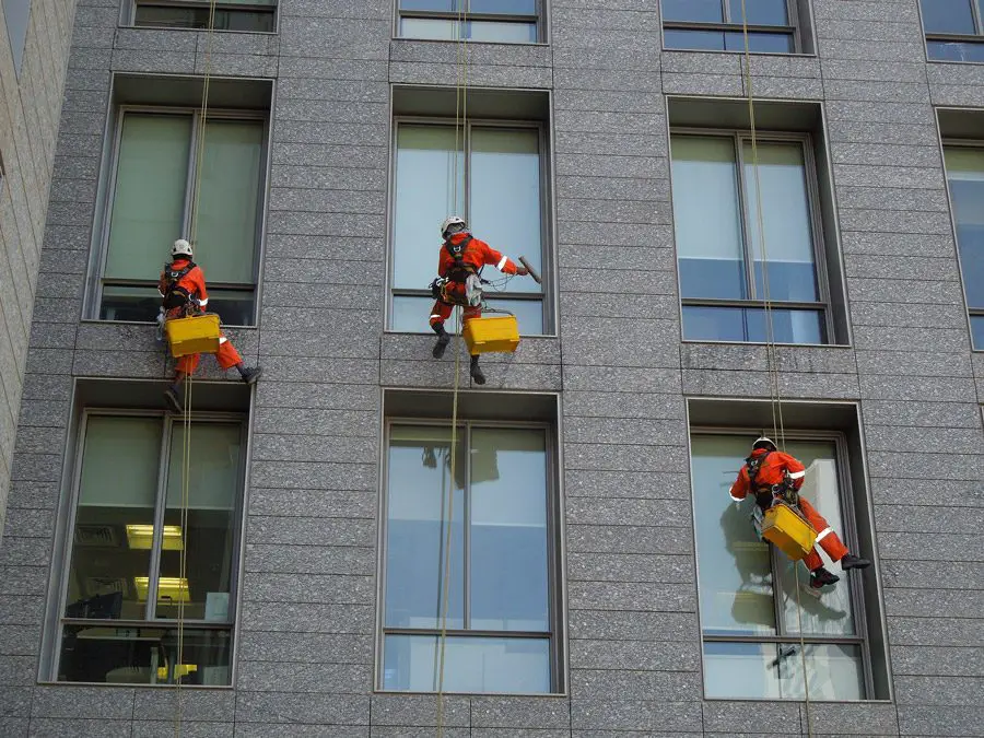 عمال ينظفون نوافذ مبنى