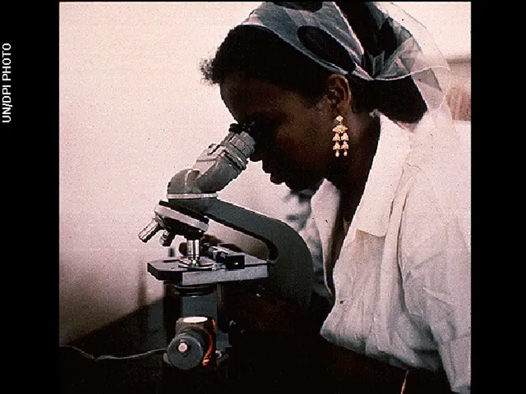 امرأة تستخدم المجهر