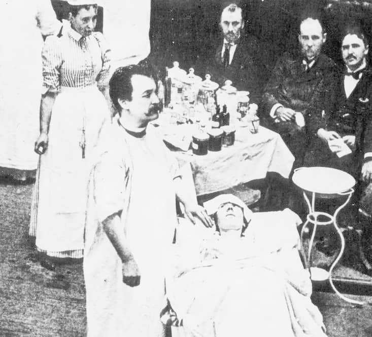 الطبيب (نيكولاس سين)، وهو يجري تجربة جراحية أمام مجموعة من طلبة الطب في سنة 1895.